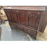 AN 18th C. OAK MULE CHEST WITH A FOUR PANELLED FRONT ABOVE THREE DRAWERS. W 143 x D 50 x H 111cms.