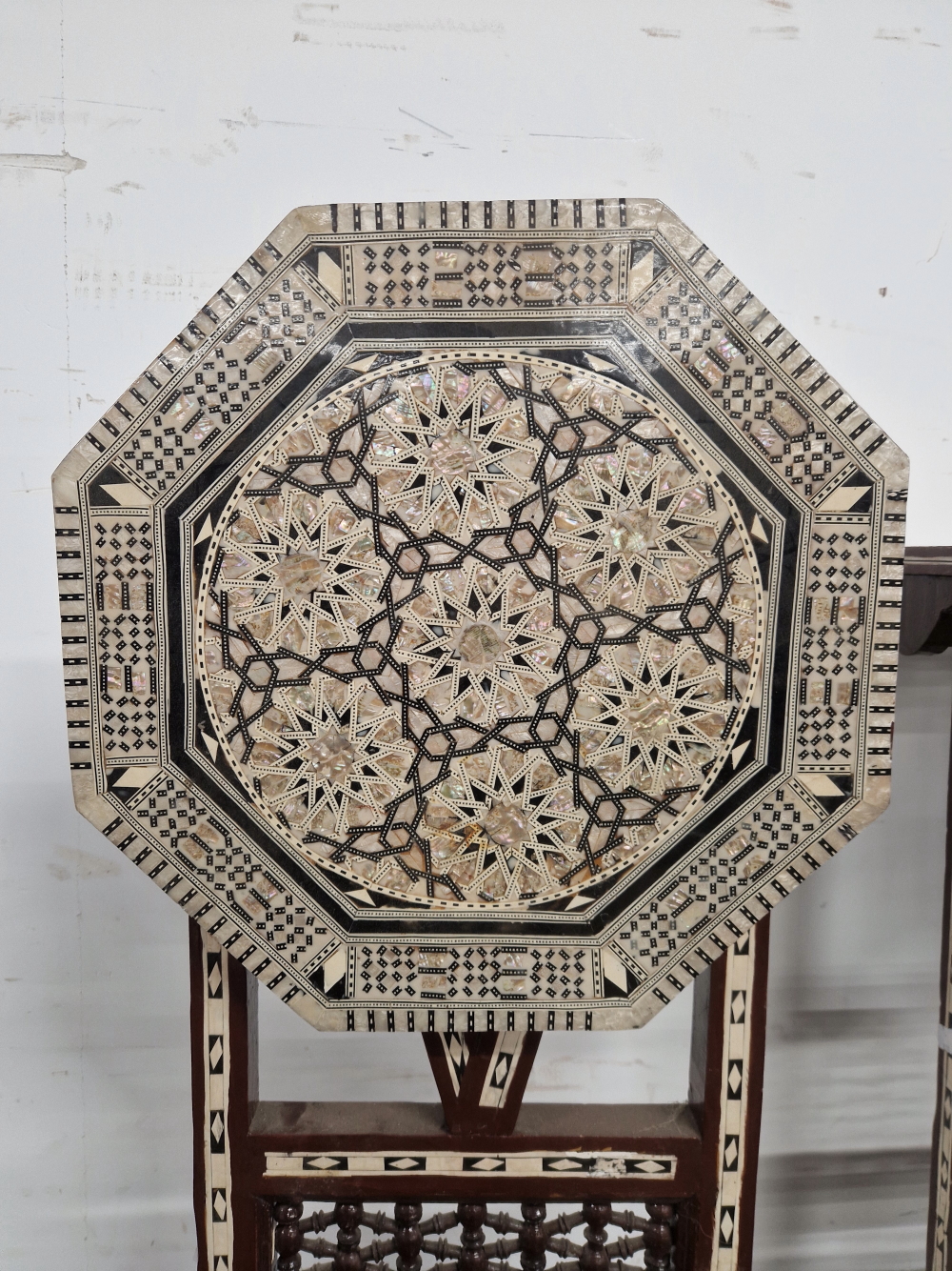 A PAIR OF ISLAMIC FOLDING OCTAGONAL TABLES GEOMETRICALLY INLAID IN MOTHER OF PEARL AND EBONY - Image 13 of 13