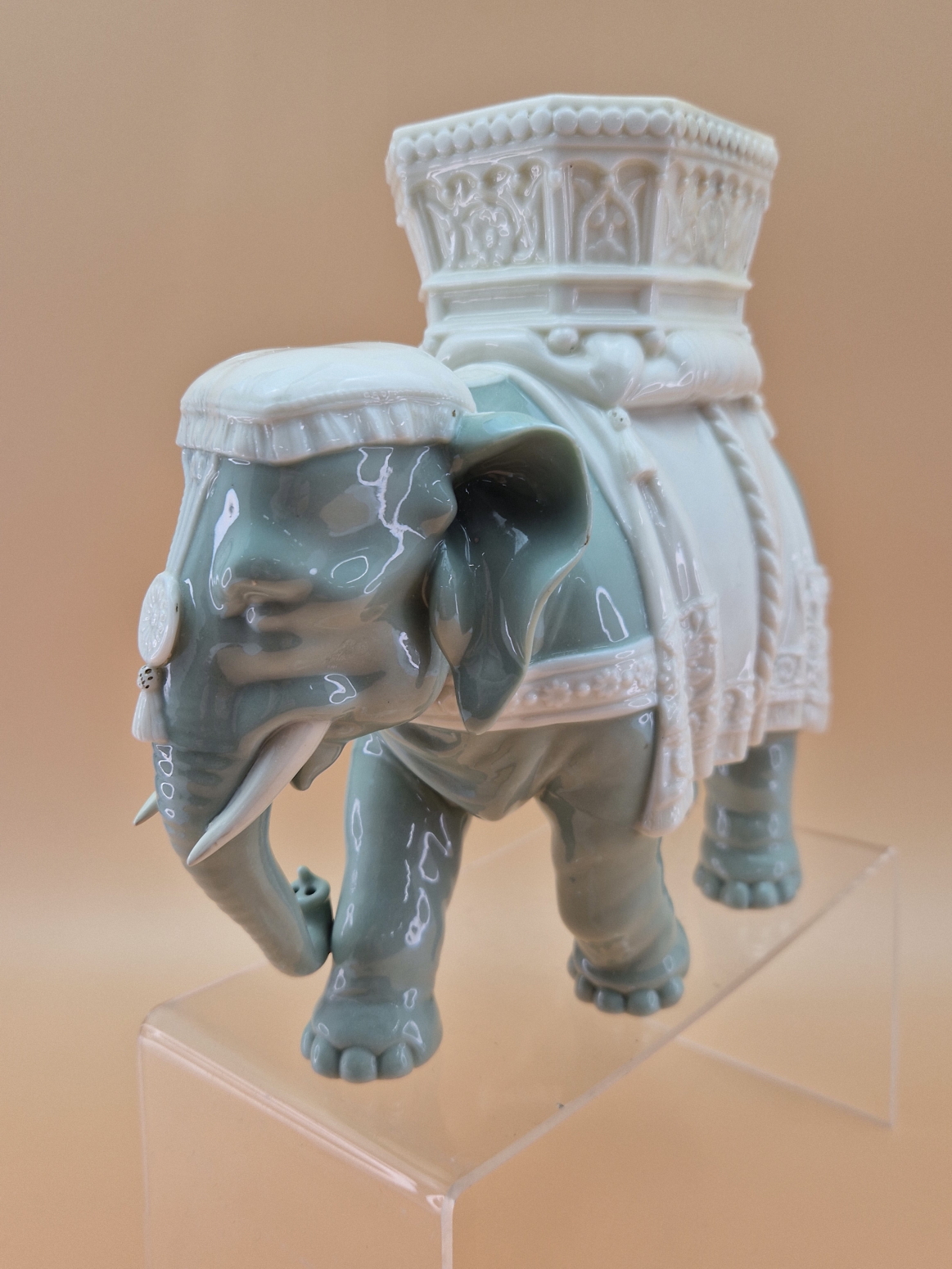 A ROYAL WORCESTER GLAZED PARIAN CELADON COLOURED ELEPHANT CAPARISSONED WITH A WHITE HOWDAH. H - Image 3 of 4