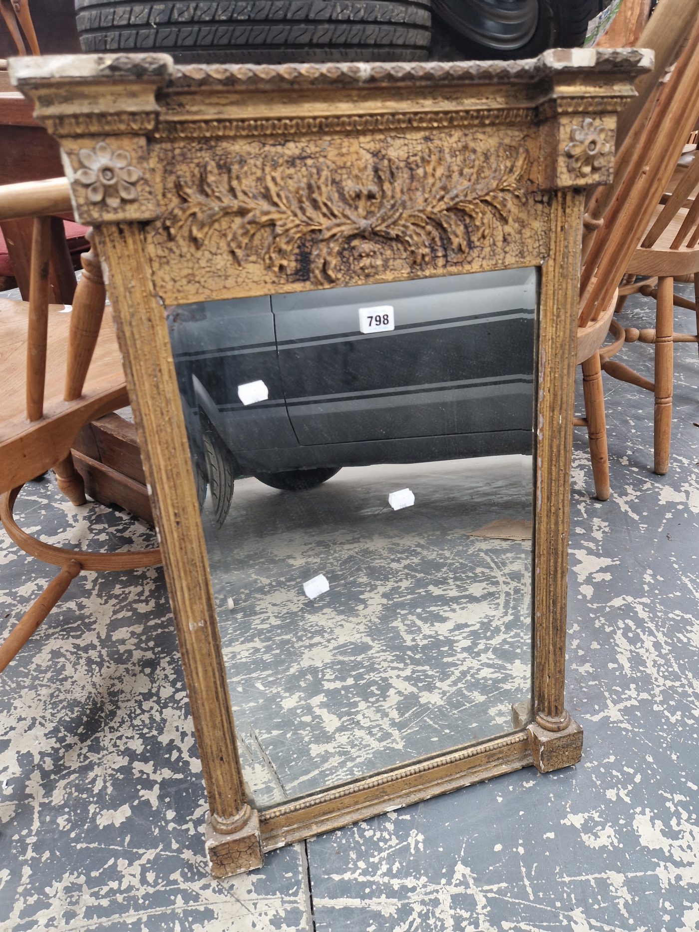 A 19th C. BEVELLED GLASS RECTANGULAR MIRROR IN A REGENCY GILT FRAME WITH FLUTED COLUMN SIDES CRESTED
