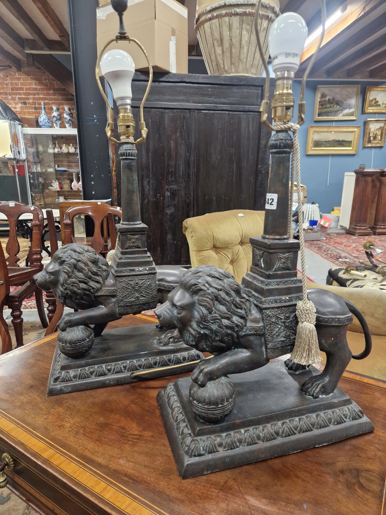 A PAIR OF BRONZE LION TABLE LAMPS, EACH STANDING WITH A FOREPAW RAISED ON A BROCADE BALL, THE - Image 3 of 3