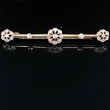 AN ANTIQUE TRIPLE DIAMOND CLUSTER BAR BROOCH. UNHALLMARKED, ASSESSED VARIOUSLY BETWEEN 14-15ct GOLD.