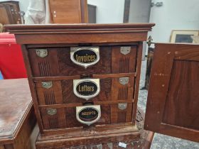 AN AMBERGS PATENT THREE DRAWER TABLE TOP FILING CABINET ENCLOSED BY A DOOR