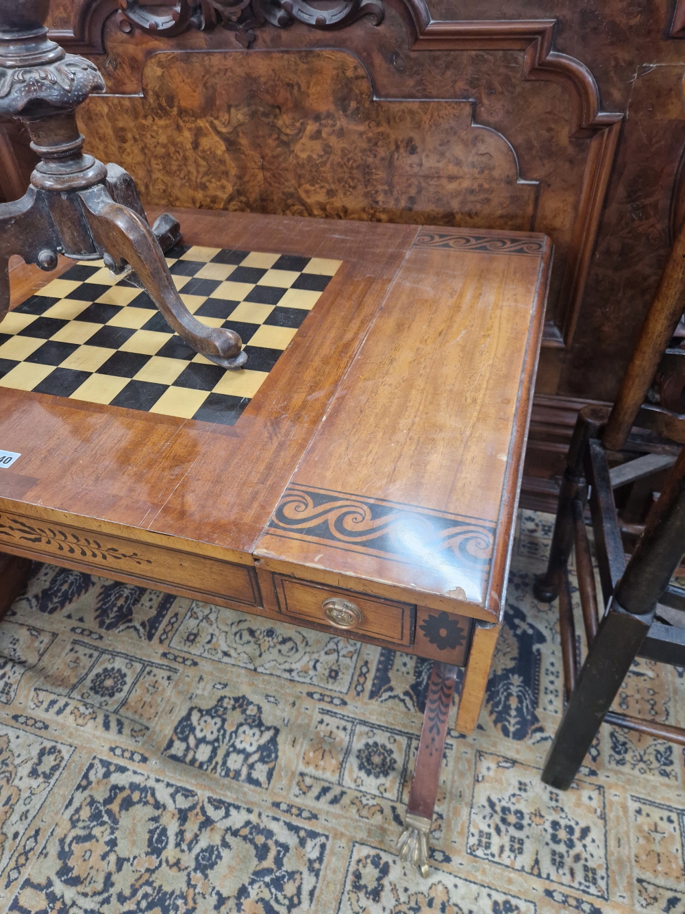 A MAHOGANY FLAP TOP GAMES TABLE DECORATED WITH AN EBONISED SCROLL BAND, THE CENTRE OF THE TOP - Image 2 of 7