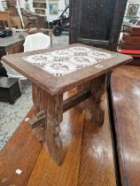 AN OAK COFFEE TABLE INSET WITH SIX DELFT MANGANESE TILES, THE PANEL LEGS PEGGED TO THE STRETCHER.