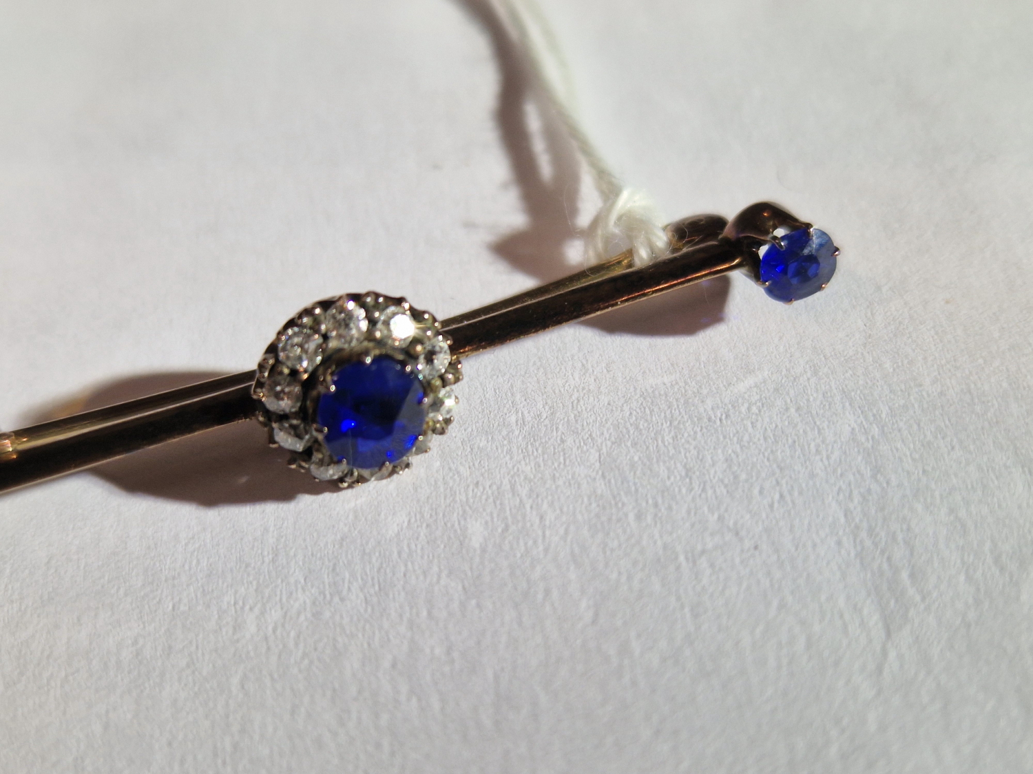 AN ANTIQUE SAPPHIRE AND DIAMOND BRA BROOCH. UNHALLMARKED, ASSESSED AS 9ct GOLD. LENGTH 4.6cms. - Image 3 of 7