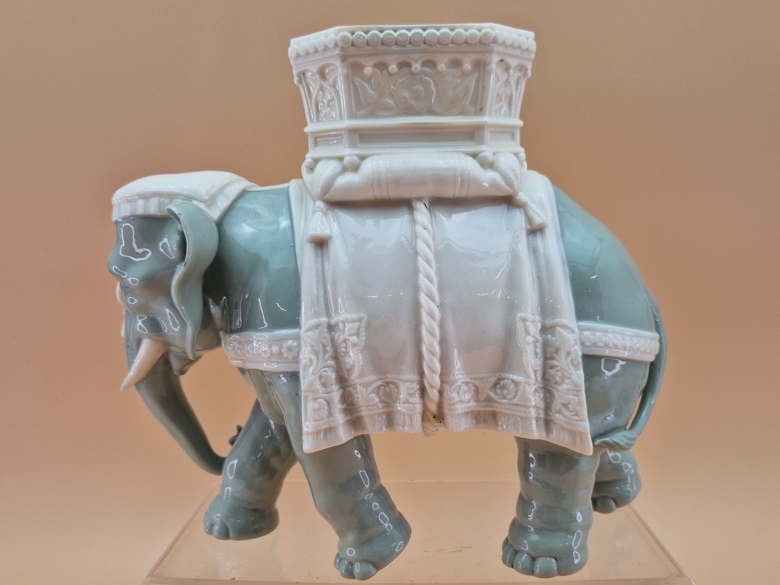 A ROYAL WORCESTER GLAZED PARIAN CELADON COLOURED ELEPHANT CAPARISSONED WITH A WHITE HOWDAH. H - Image 2 of 4