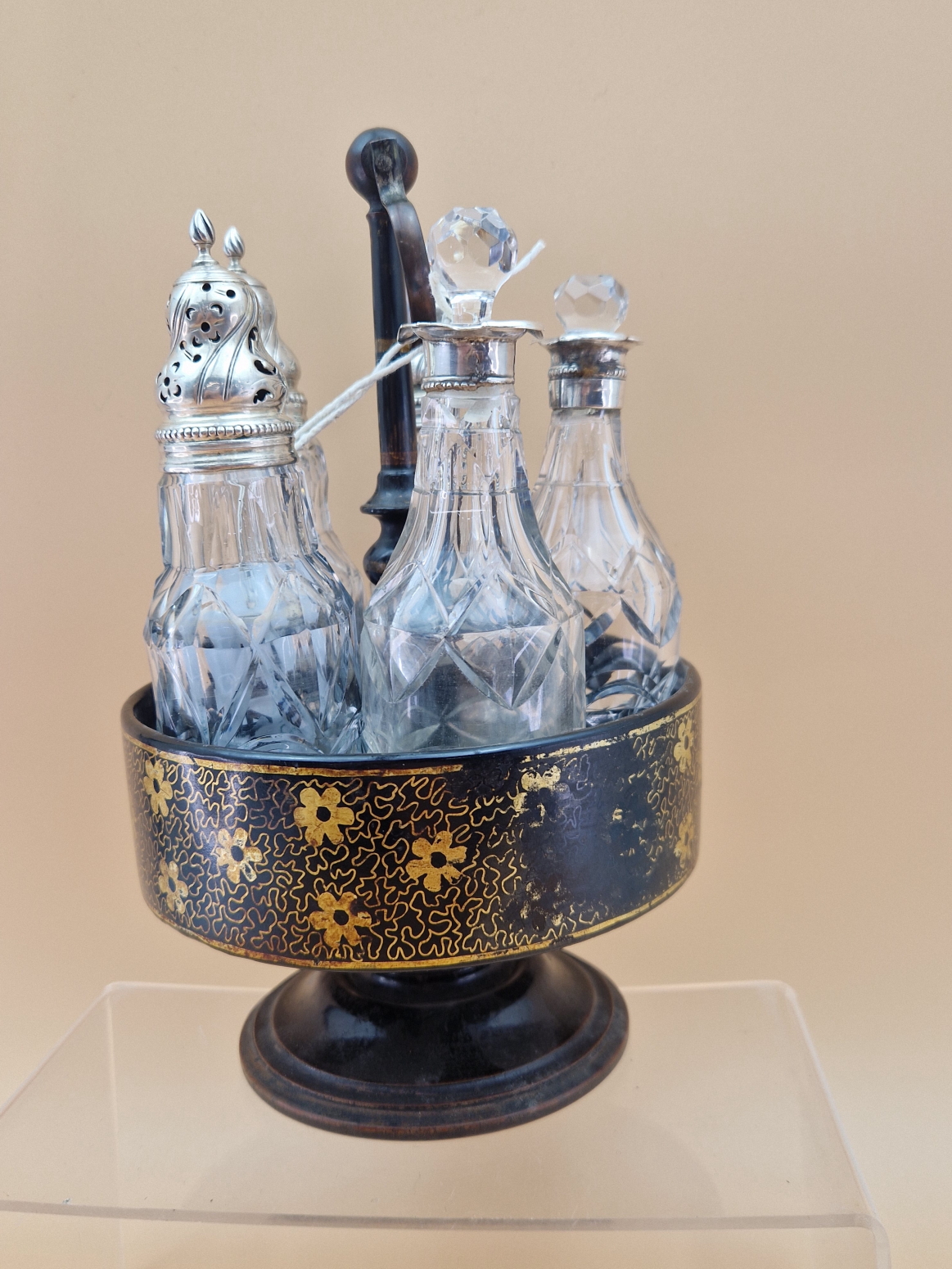 A FLORAL GILT BLACK PAPIER MACHE CRUET STAND WITH FIVE CUT GLASS BOTTLES WITH WHITE METAL MOUNTS, - Image 6 of 8