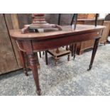 A 19th C. MAHOGANY TABLE WITH A ROUNDED FRONT TO THE RECTANGULAR TOP ON TURNED CYLINDRICAL LEGS
