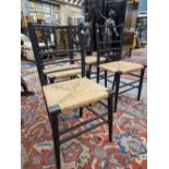 A SET OF FOUR WILLIAM MORRIS EBONISED CHAIRS WITH RUSH SEATS