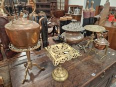 A COPPER EPERGNE, THREE BRASS TRIVETS, A COPPER KETTLE AND ANOTHER ON A BRASS STAND