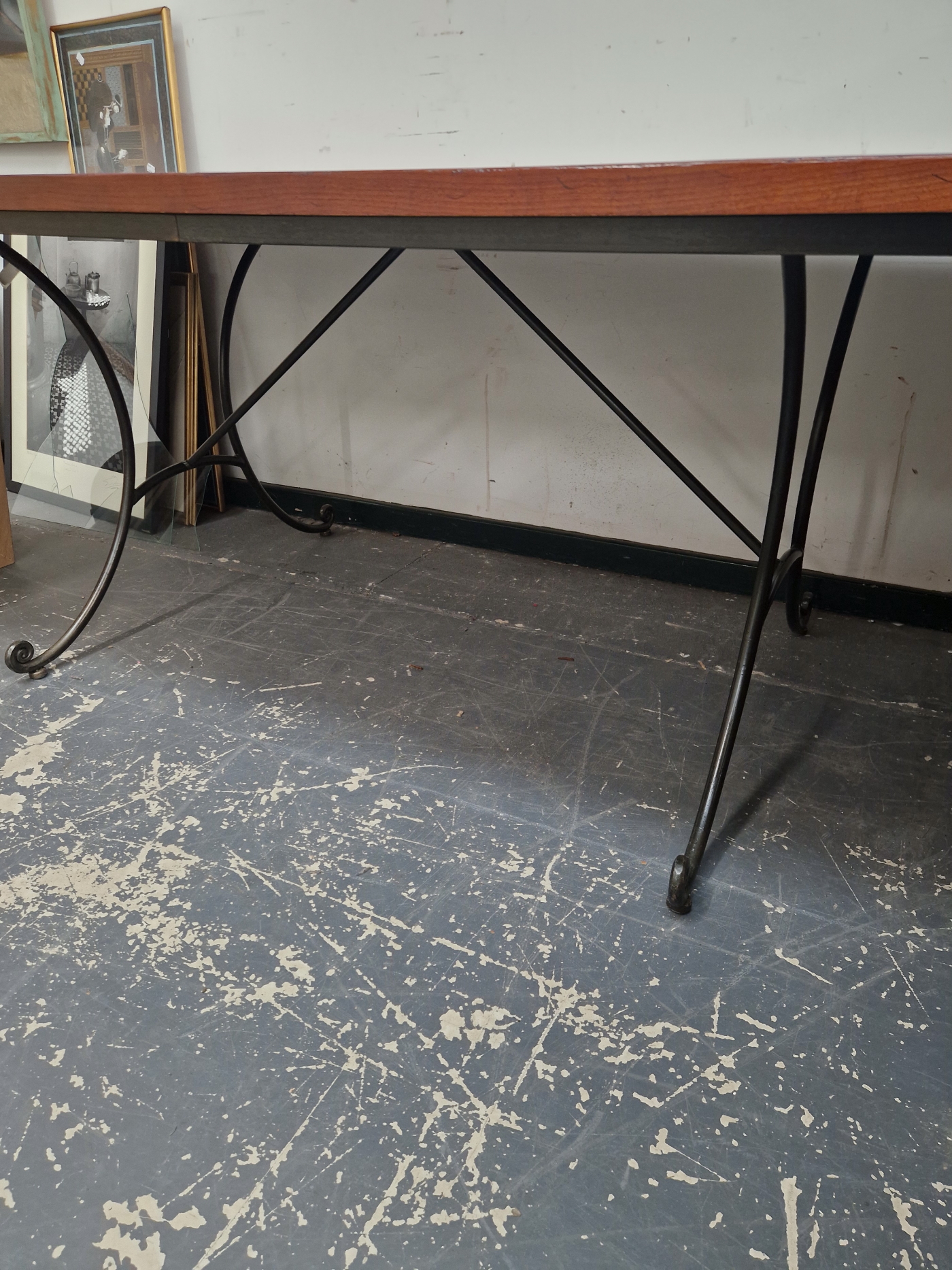 A STAINED WOOD CLEATED PLANK TOP RECTANGULAR REFECTORY TABLE ON CURVED IRON LEGS. W 183 x D 102 x - Image 2 of 2