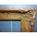 A LARGE 19TH CENTURY GILTWOOD AND GESSO PICTURE FRAME.