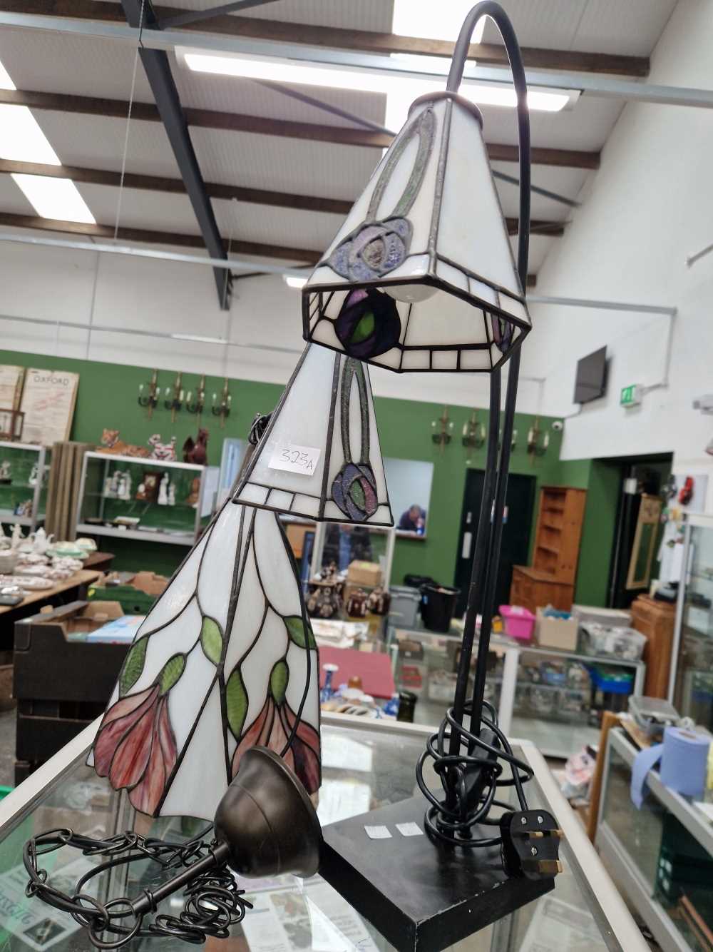 A table lamp with two leaded glass shades together with a similar ceiling light