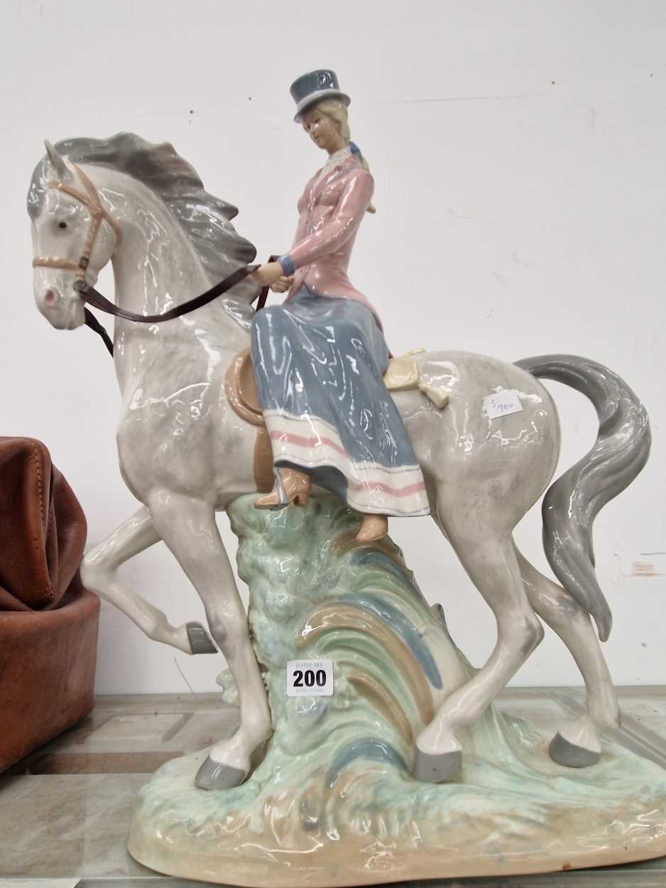 A Rex porcelain Lladro style porcelain figure of a lady riding side saddle
