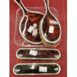 A hallmarked silver and tortoise shell four piece brush and mirror set.