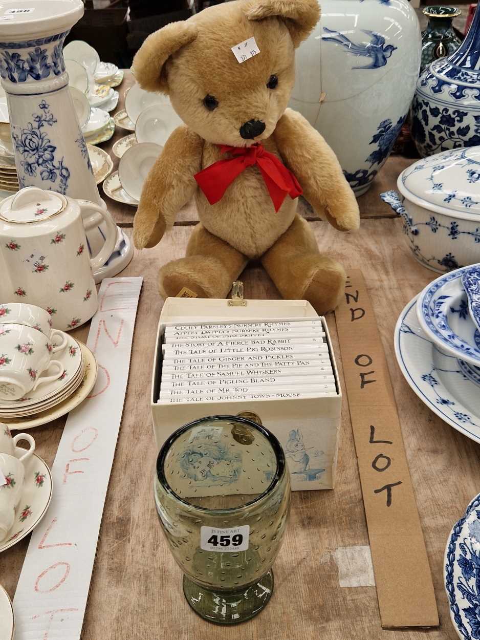 A Merrythought teddy bear, a set of Beatrix Potter books and an art glass vase