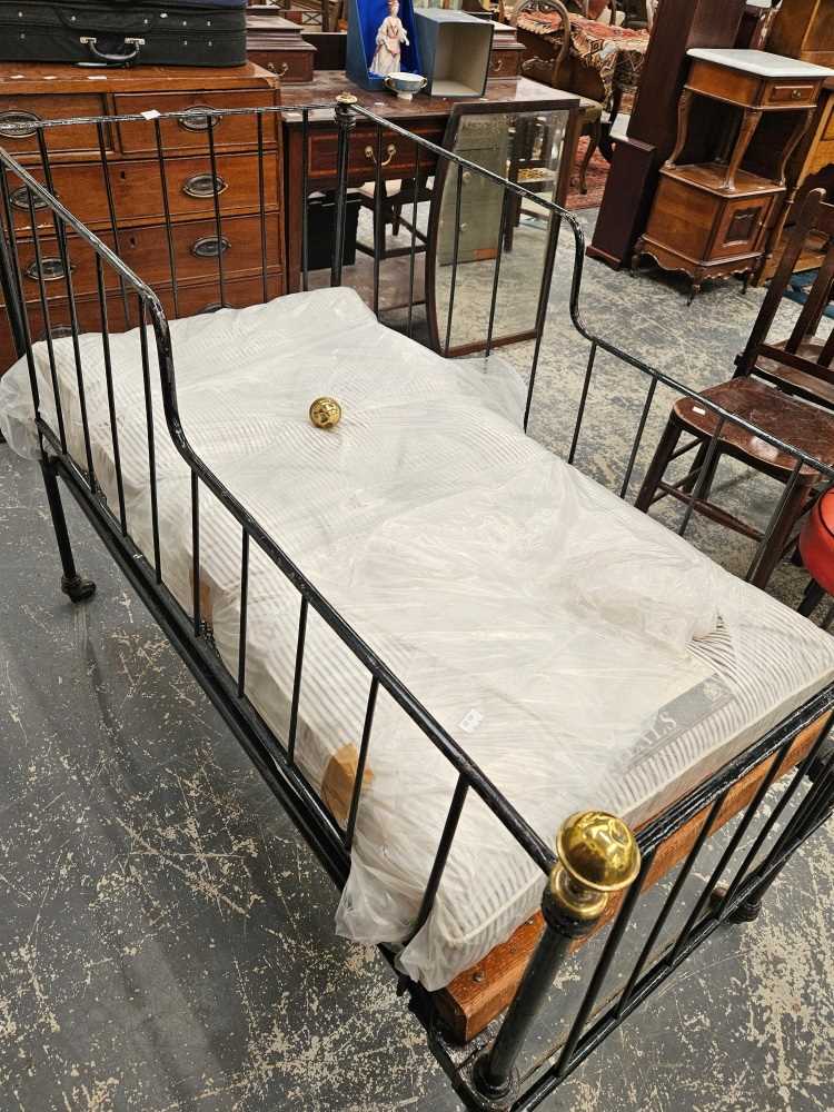 An antique wrought iron folding childs bed / day bed with bespoke mattress.