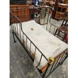 An antique wrought iron folding childs bed / day bed with bespoke mattress.