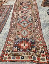 AN ANTIQUE CAUCASIAN TRIBAL RUNNER 304 x 114 cm.