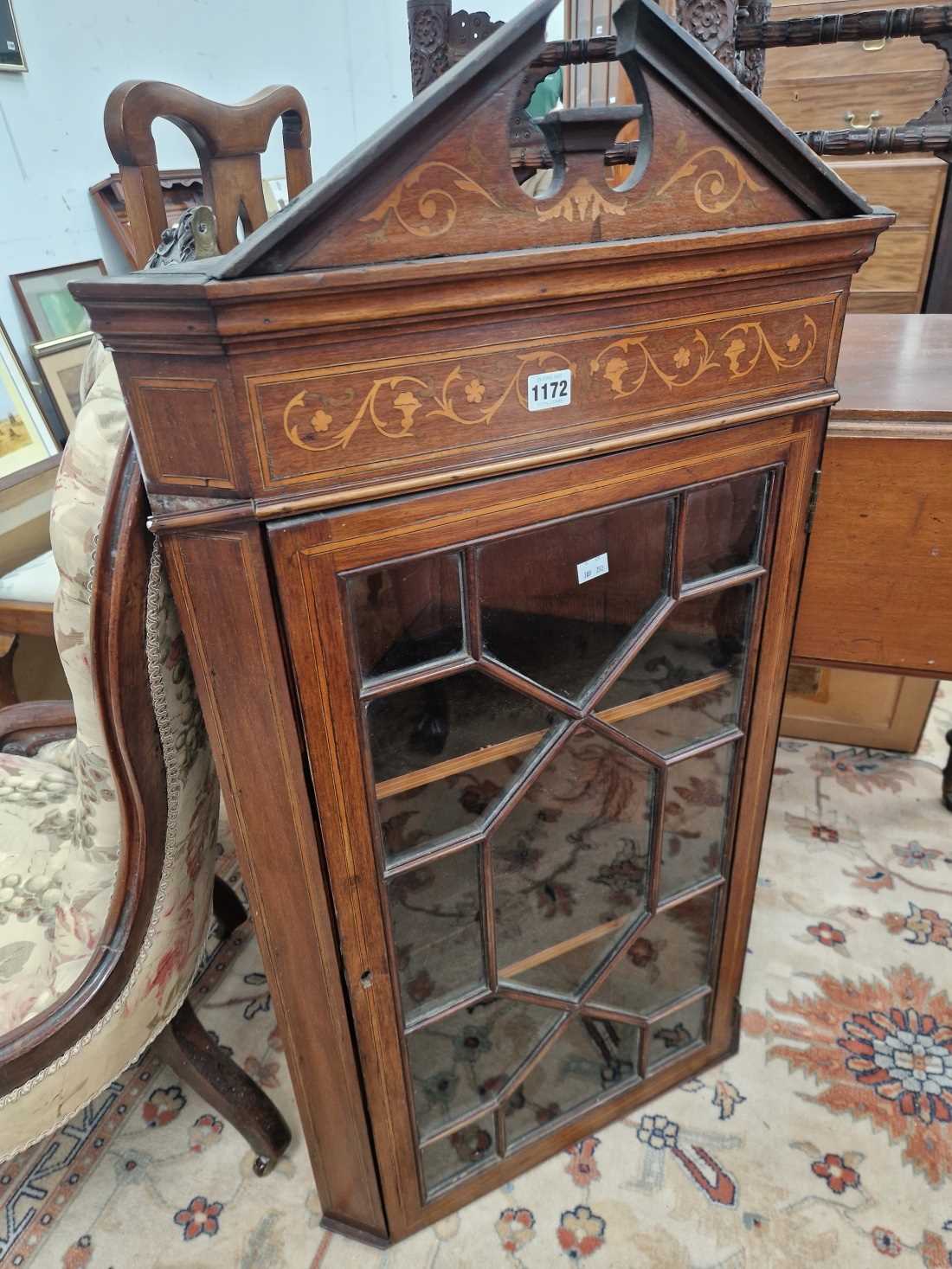 A mahogany inlaid glazed corner cabinet.