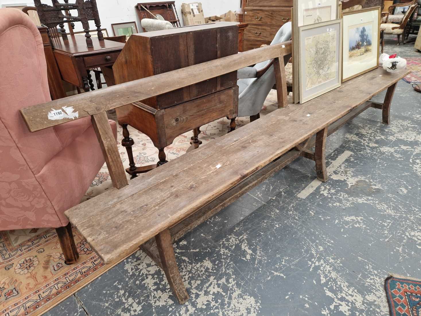 A long rustic pine bench.