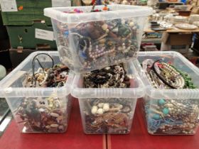Four large boxes of various costume beads, necklaces, and other dress jewellery.