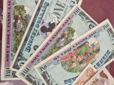 Four vintage Disney Dollar banknotes and various other world banknotes.