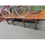 A pair of low mahogany drop leaf tables.