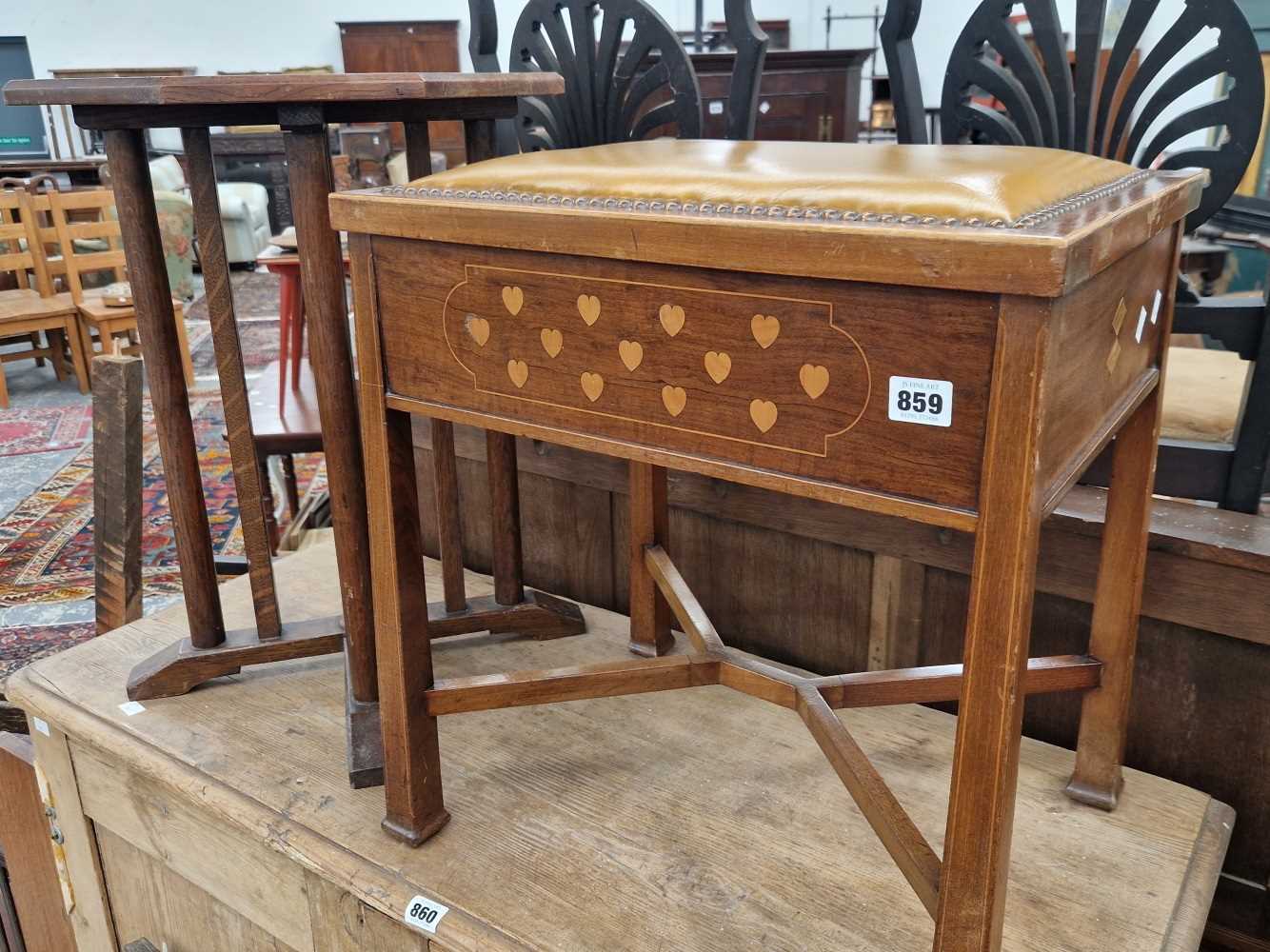 An Art and Crafts mahogany and inlaid piano stool in the Voysey manner and an oak occasional table.