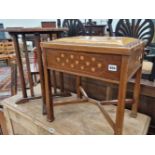 An Art and Crafts mahogany and inlaid piano stool in the Voysey manner and an oak occasional table.