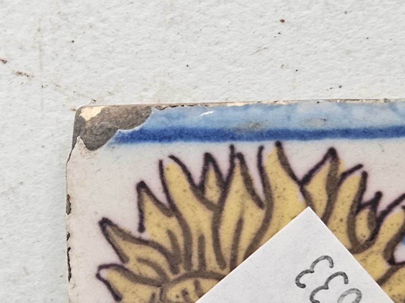 A tin glazed tile painted in blue, yellow and aubergine with a sunflower 15 x 15 cm - Image 4 of 15