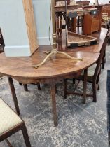 Georgian mahogany cross banded D end dining table with three leaves .