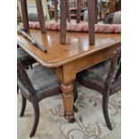 A Victorian mahogany dining table on turned legs.