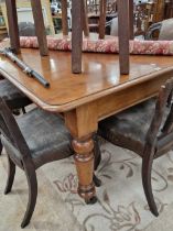 A Victorian mahogany dining table on turned legs.