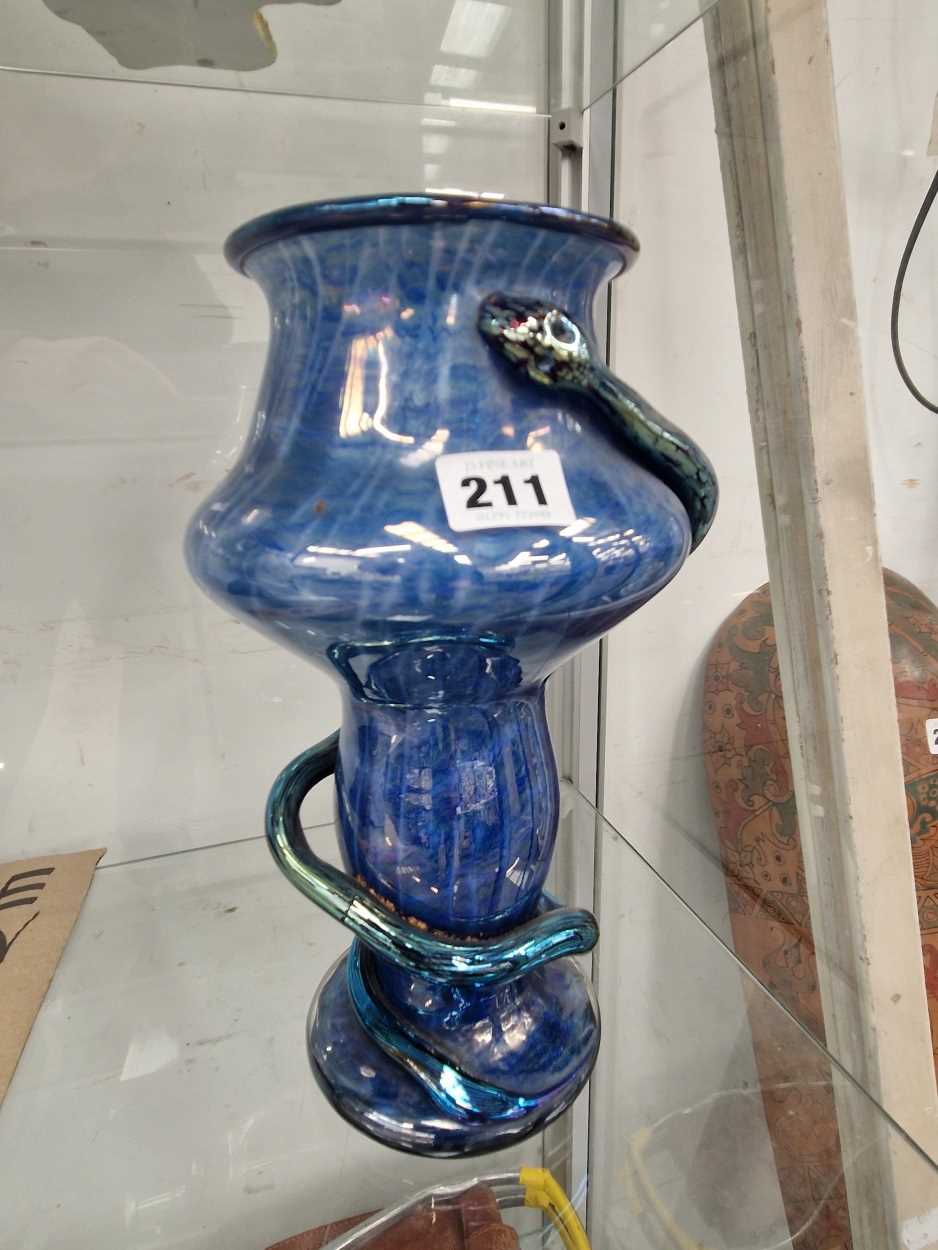 A Loetz type blue art glass vase entwined by a snake.