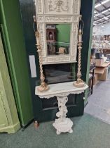 A console table with cherub support and mirror over.