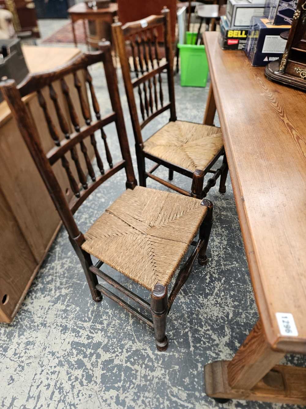 A set of four spindle back kitchen chairs with rush seats