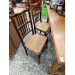 A set of four spindle back kitchen chairs with rush seats