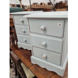 A pair of painted pine three drawer small chests.