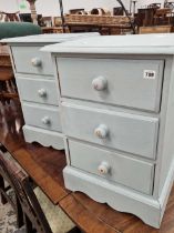 A pair of painted pine three drawer small chests.