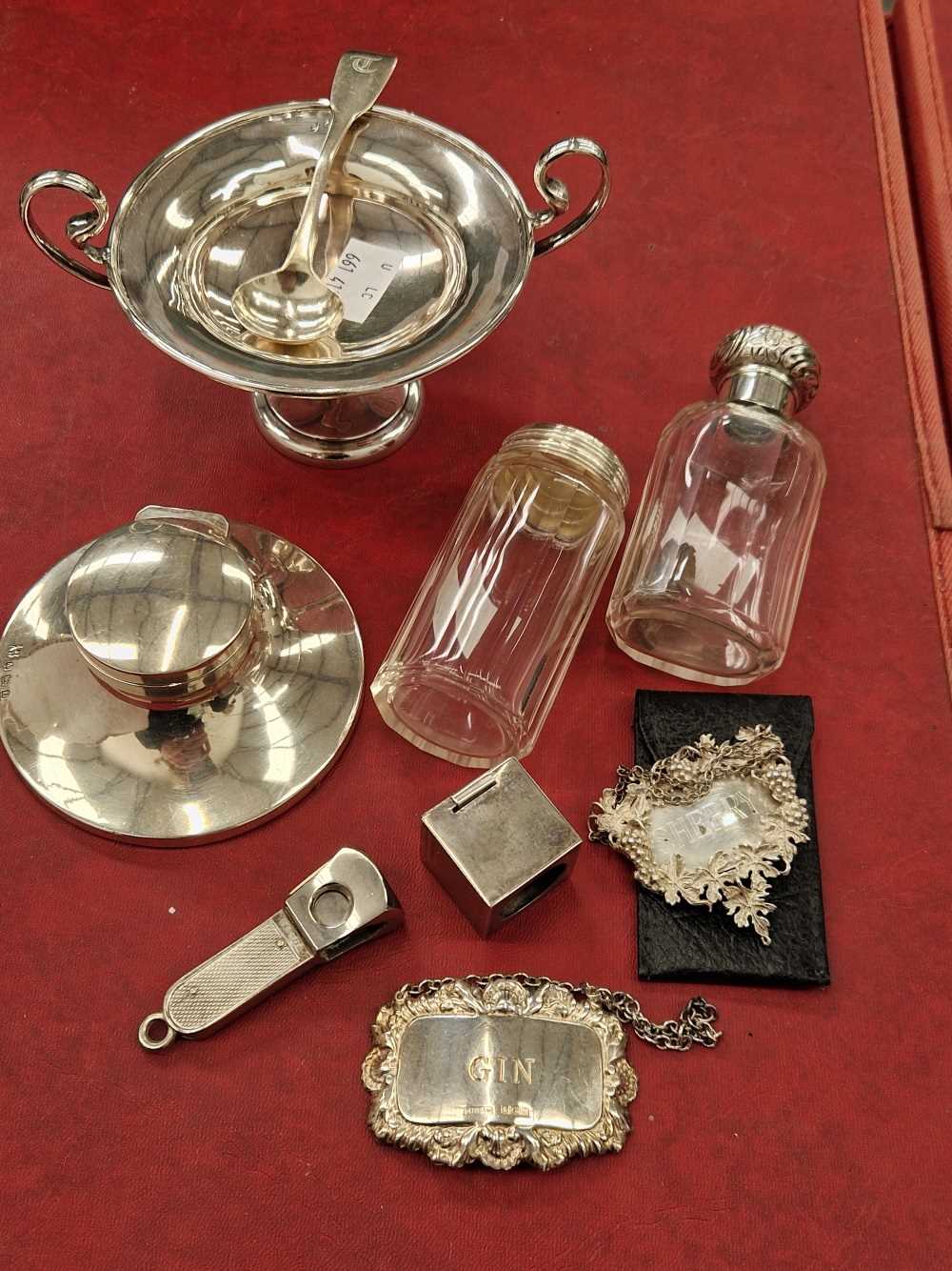 Two hallmarked silver decanter labels, a small tazza, a capston inkwell, cigar cutter, mustard