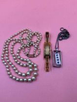 A ladies Gucci watch, reference number 3900L, a double row of Circo pearls with a 9ct gold clasp,