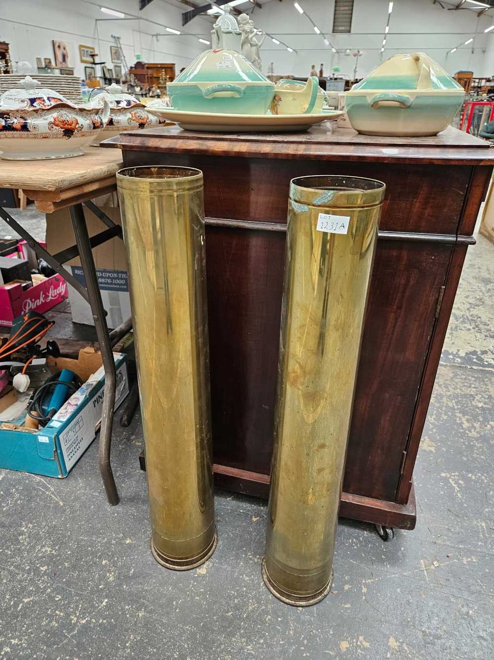 A pair of brass shell cases 79cm tall.
