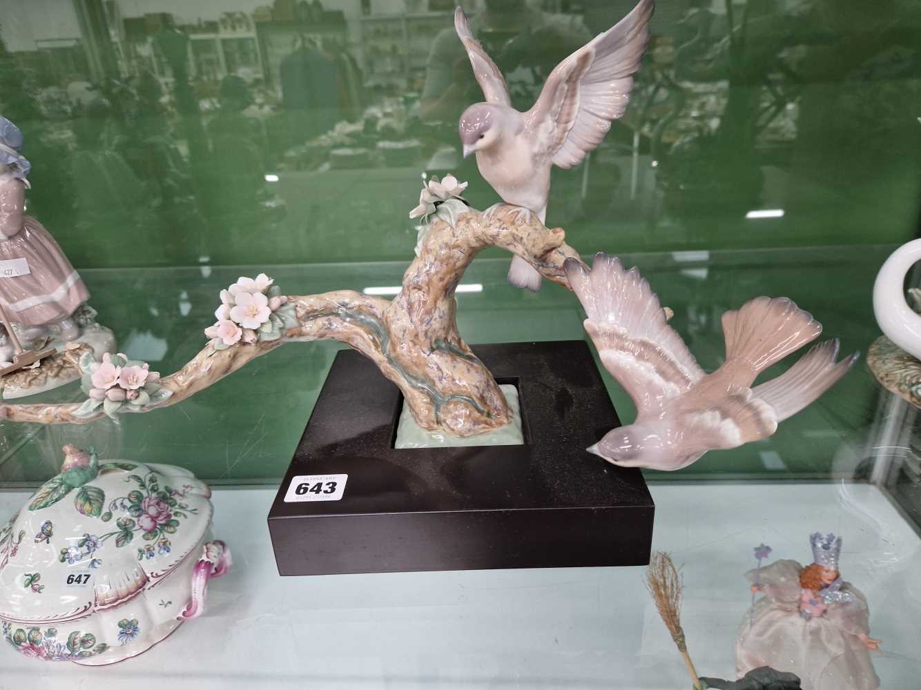 A Lladro sculpture, birds on a branch.