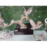 A Lladro sculpture, birds on a branch.