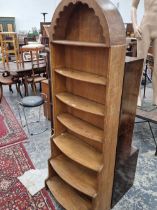A tall oak waterfall bookcase. H 175cms W 61cms D 30cms
