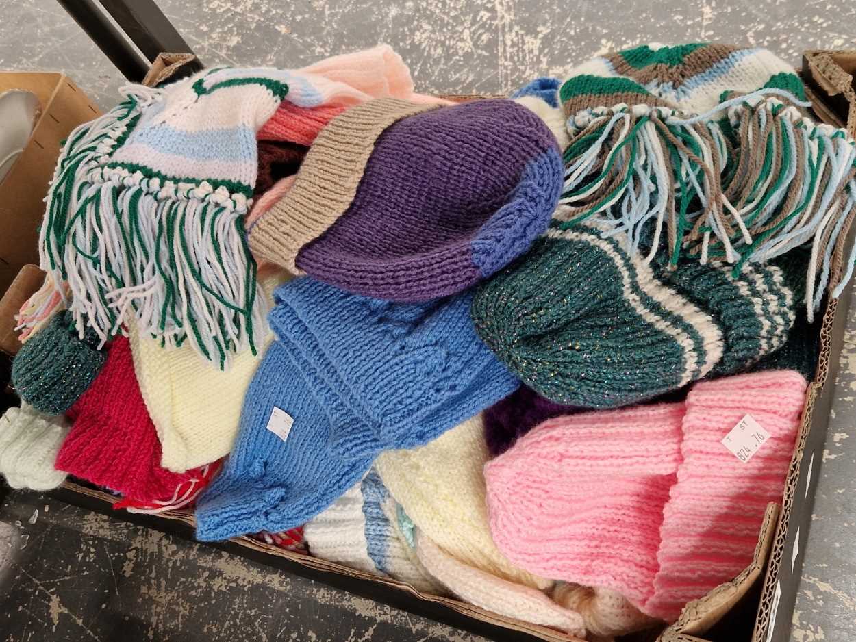 A quantity of various woollen bobble hats
