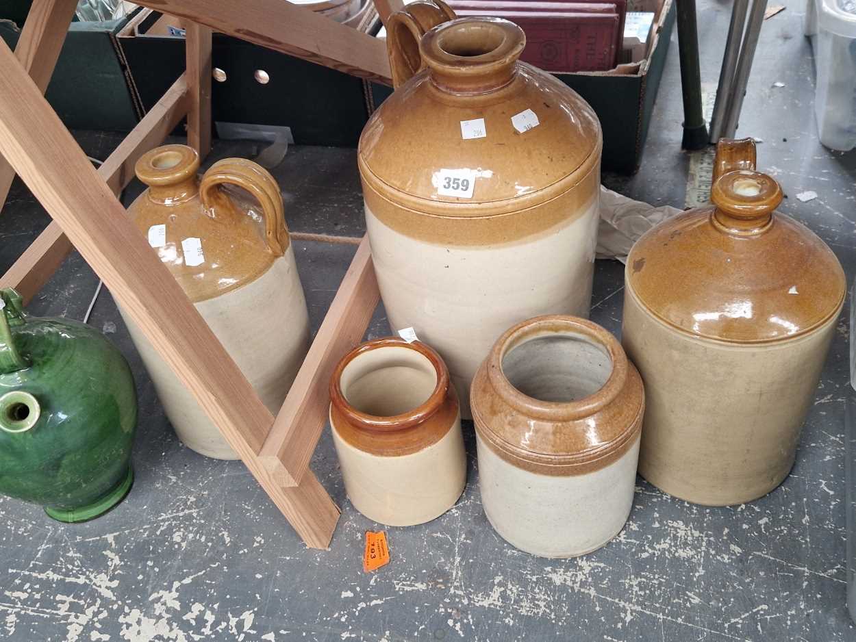 Three uninscribed stoneware flasks, two jars and a green glazed wine ewer and a quantity of tins