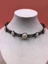 A vintage opal, marcasite and continental silver choker necklace. Set with eight graduated opals,